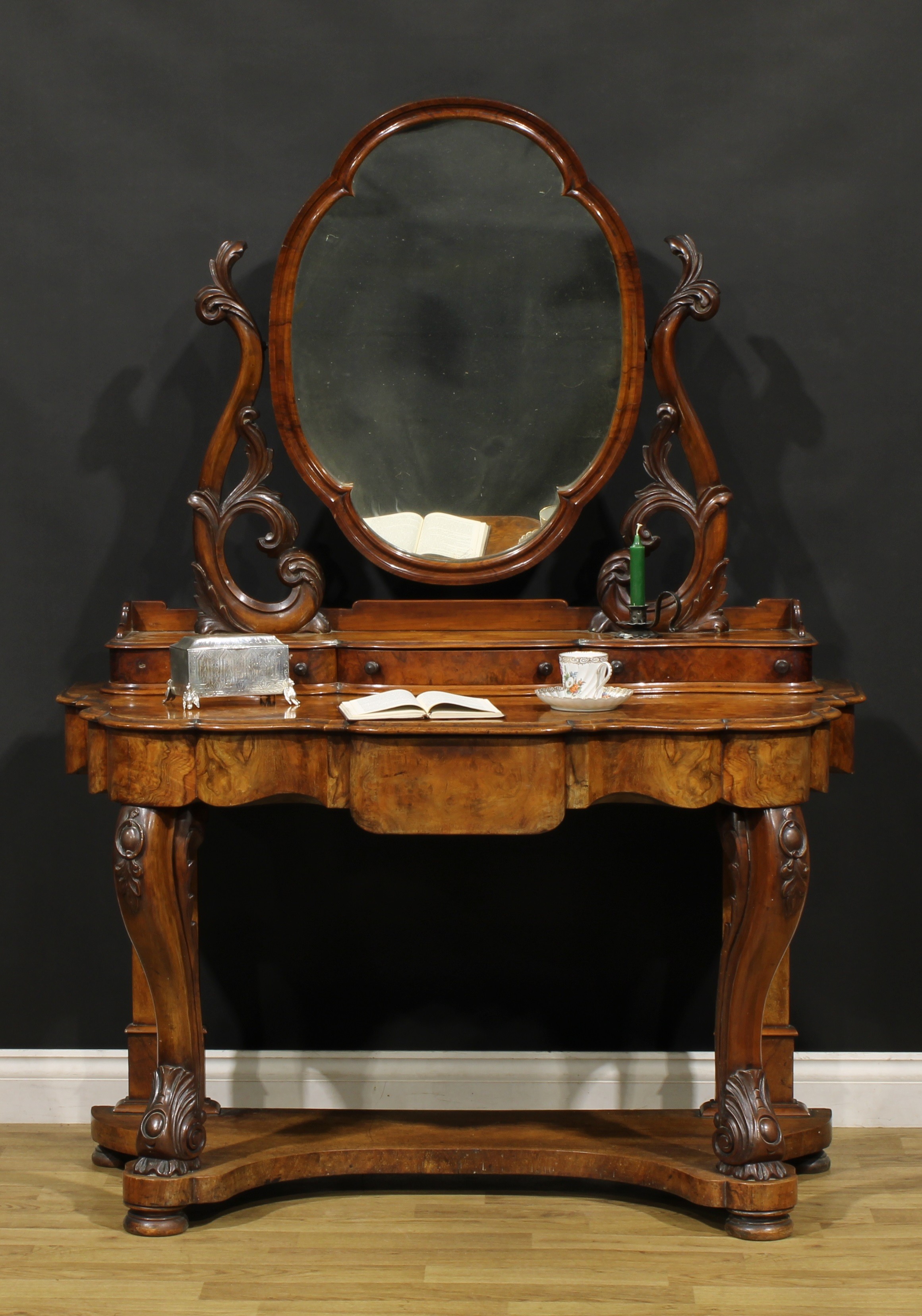 A Victorian walnut duchess dressing table, the superstructure with shaped mirror above three
