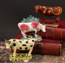 An early 19th Staffordshire spongeware cow creamer, as a dairy cow, 12cm; a 19th century