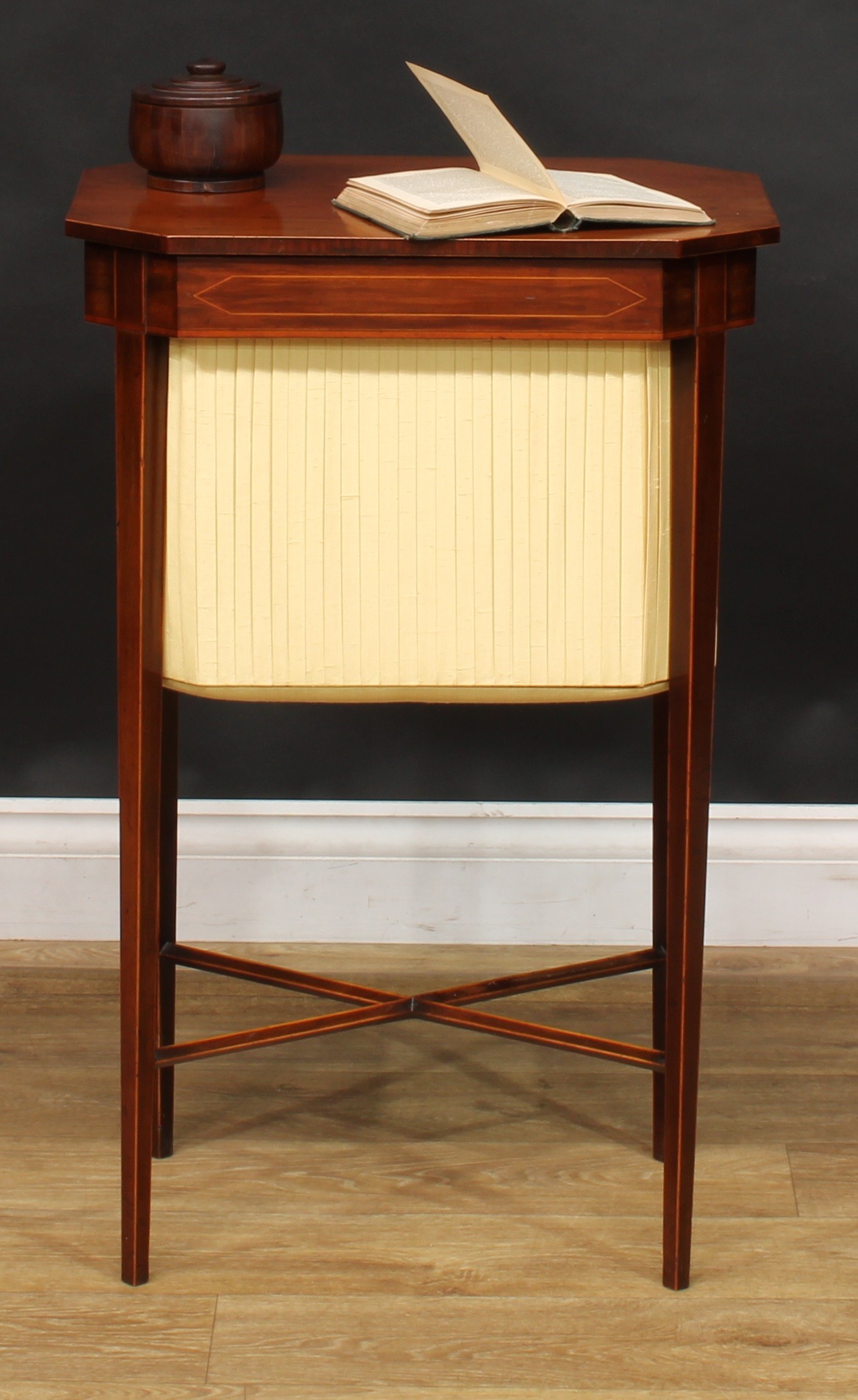 A George III mahogany work table, hinged canted rectangular top, pleated undertier, tapered legs,