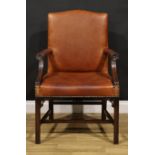 A Chippendale Revival mahogany Gainsborough armchair, stuffed-over leather upholstery, the hand