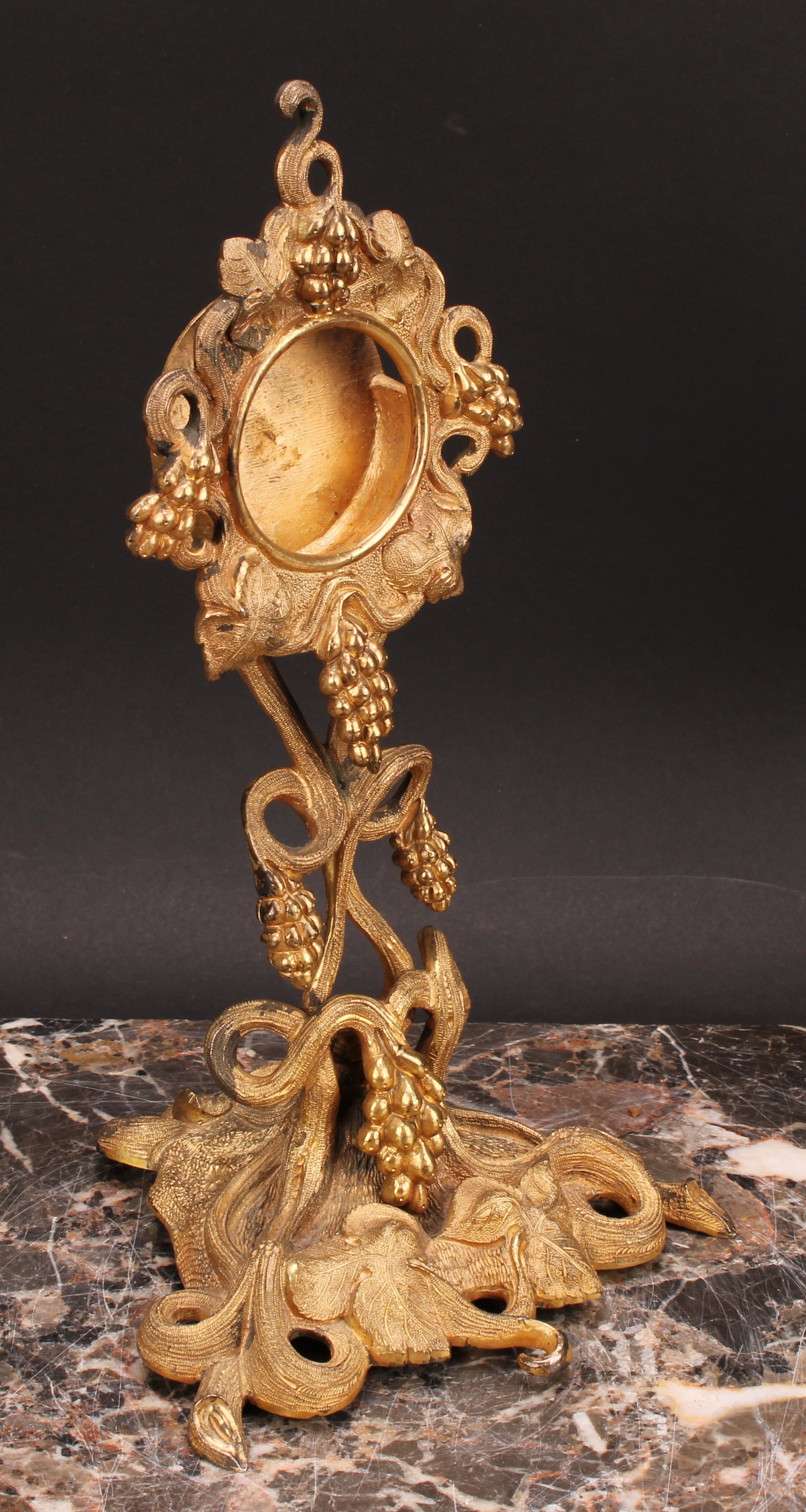 An early 20th century gilt metal pocket watch stand, cast throughout with fruiting vine, triform - Image 2 of 4