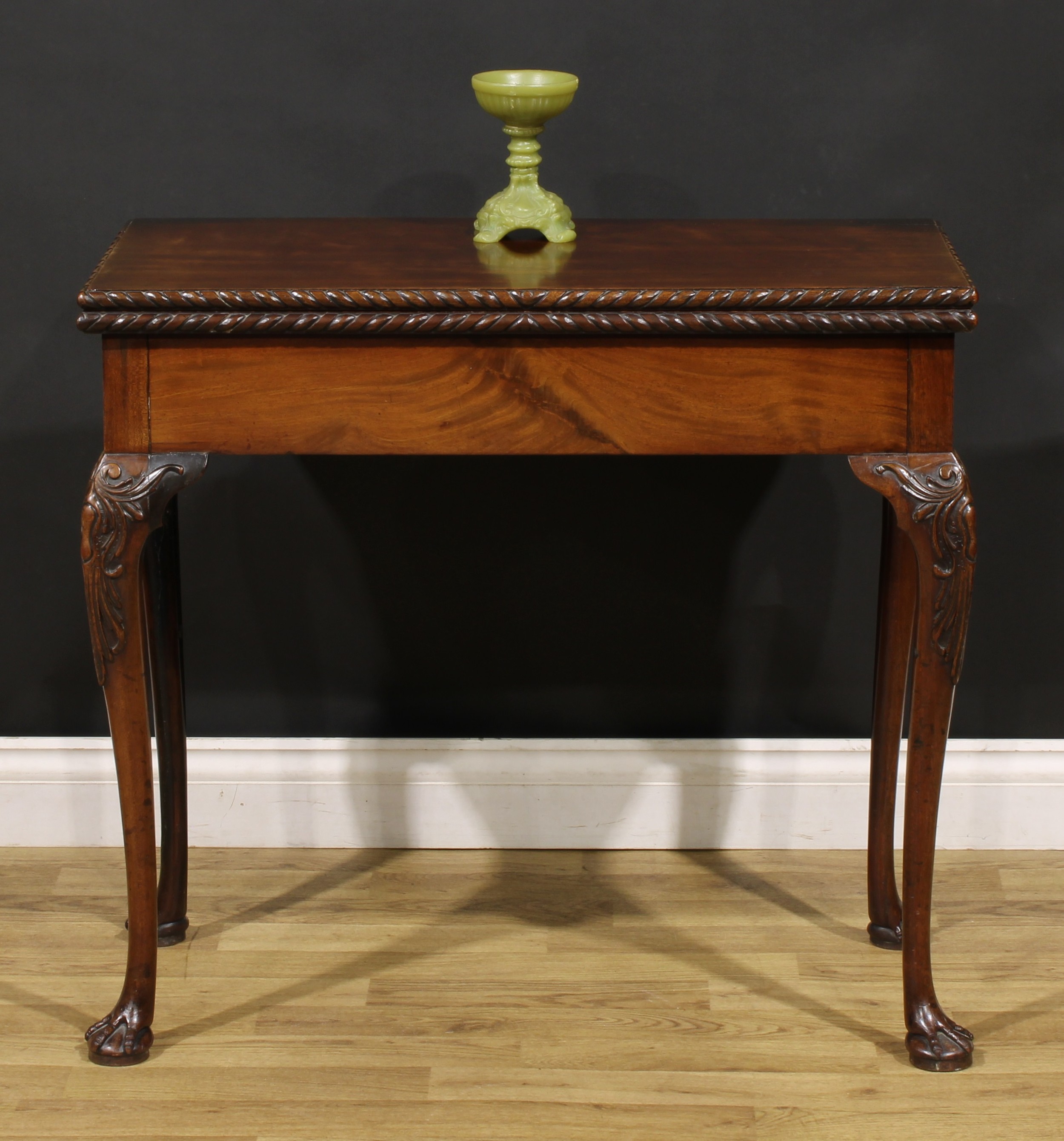 A 19th century mahogany card table, possibly Irish, hinged top with gadroon-and-ribbon edge