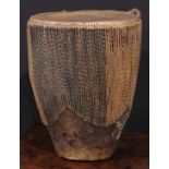 A Ugandan embuutu drum, hide bound hard wood, twin suspension loops, 39cm high, late 19th/early 20th