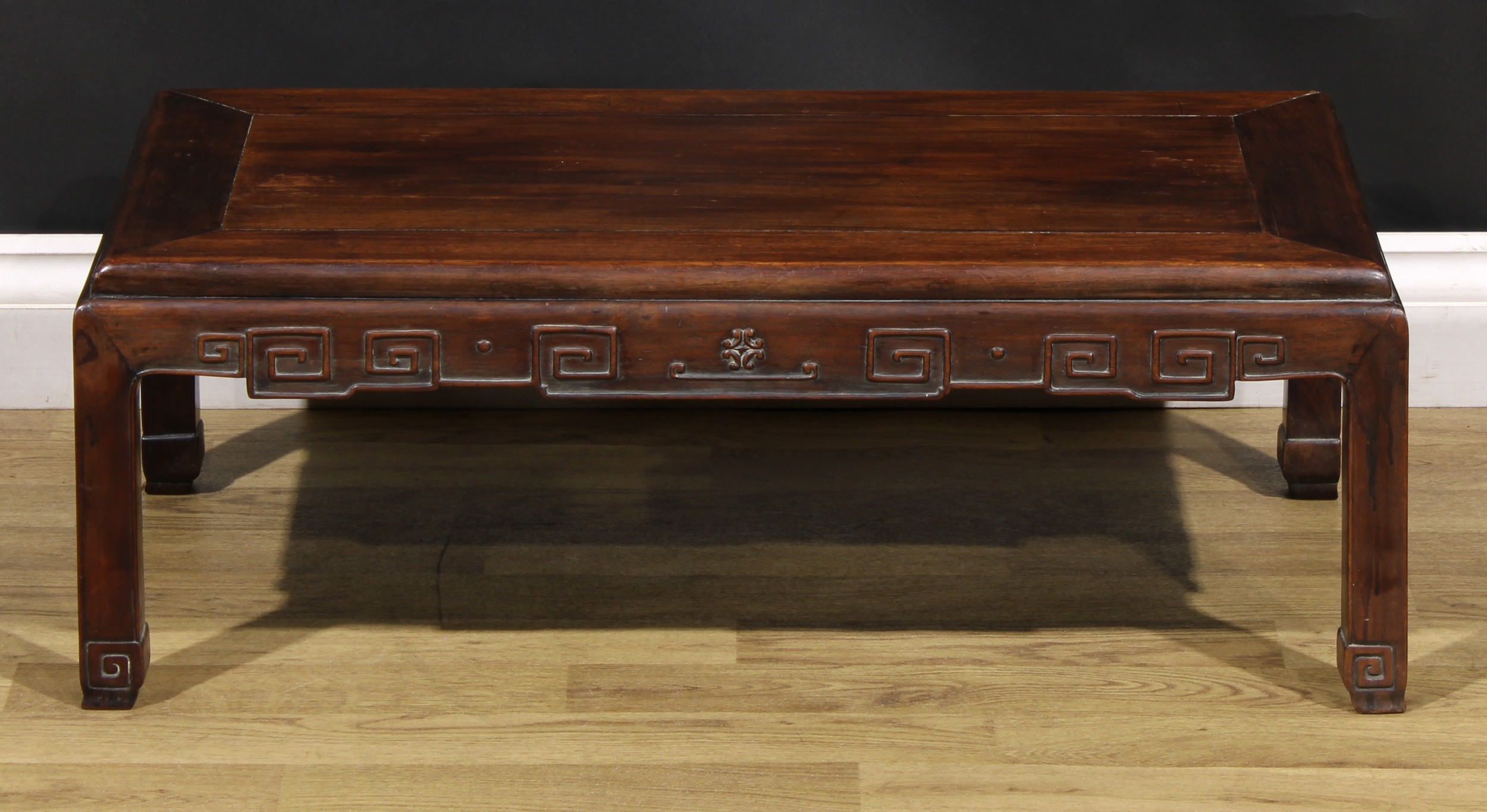 A Chinese hardwood low tea table, panel top, shaped apron carved with angular stylised clouds, - Image 2 of 5