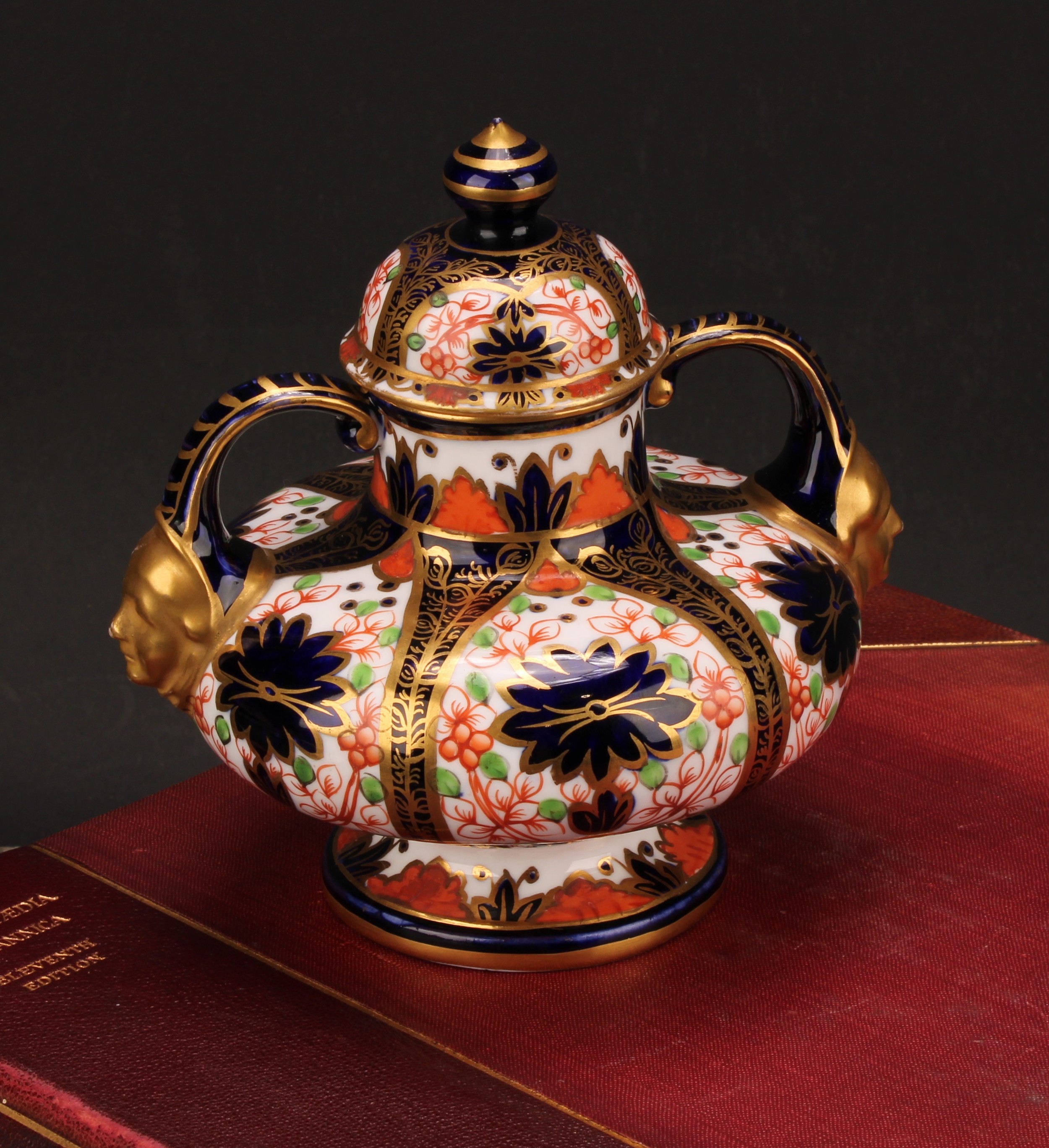 A Royal Crown Derby Imari pattern compressed ovoid two-handled pedestal vase, domed cover, scroll