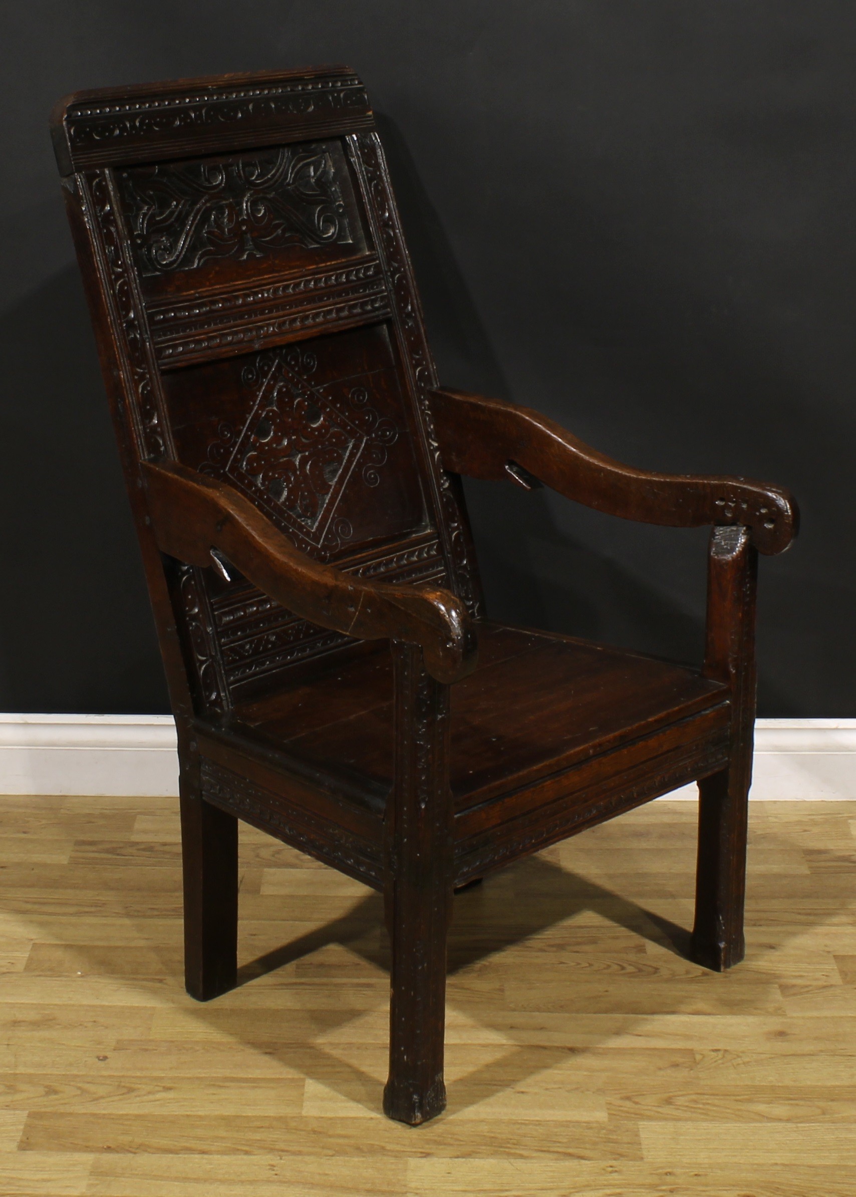 A 17th century oak wainscot armchair, rectangular panel back carved with lozenges and leafy scrolls, - Image 2 of 4