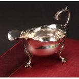 A George III silver sauce boat, acanthus-capped flying scroll handle, wavy rim, hoof feet, 13cm