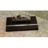 Automobilia - an Elizabeth II silver mounted desk stand, applied with a cast model of a Ford Sierra,