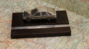 Automobilia - an Elizabeth II silver mounted desk stand, applied with a cast model of a Ford Sierra,