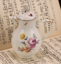 A mid 18th century Meissen baluster jug and cover, painted with flowers, moulded basket weave