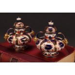 A pair of Royal Crown Derby Imari pattern compressed ovoid two-handled pedestal vases, domed covers,