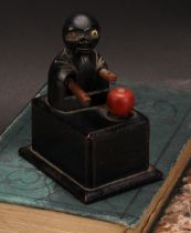 A Japanese Kobe mechanical wooden toy, as a comical figure eating an apple, rectangular base, 9cm