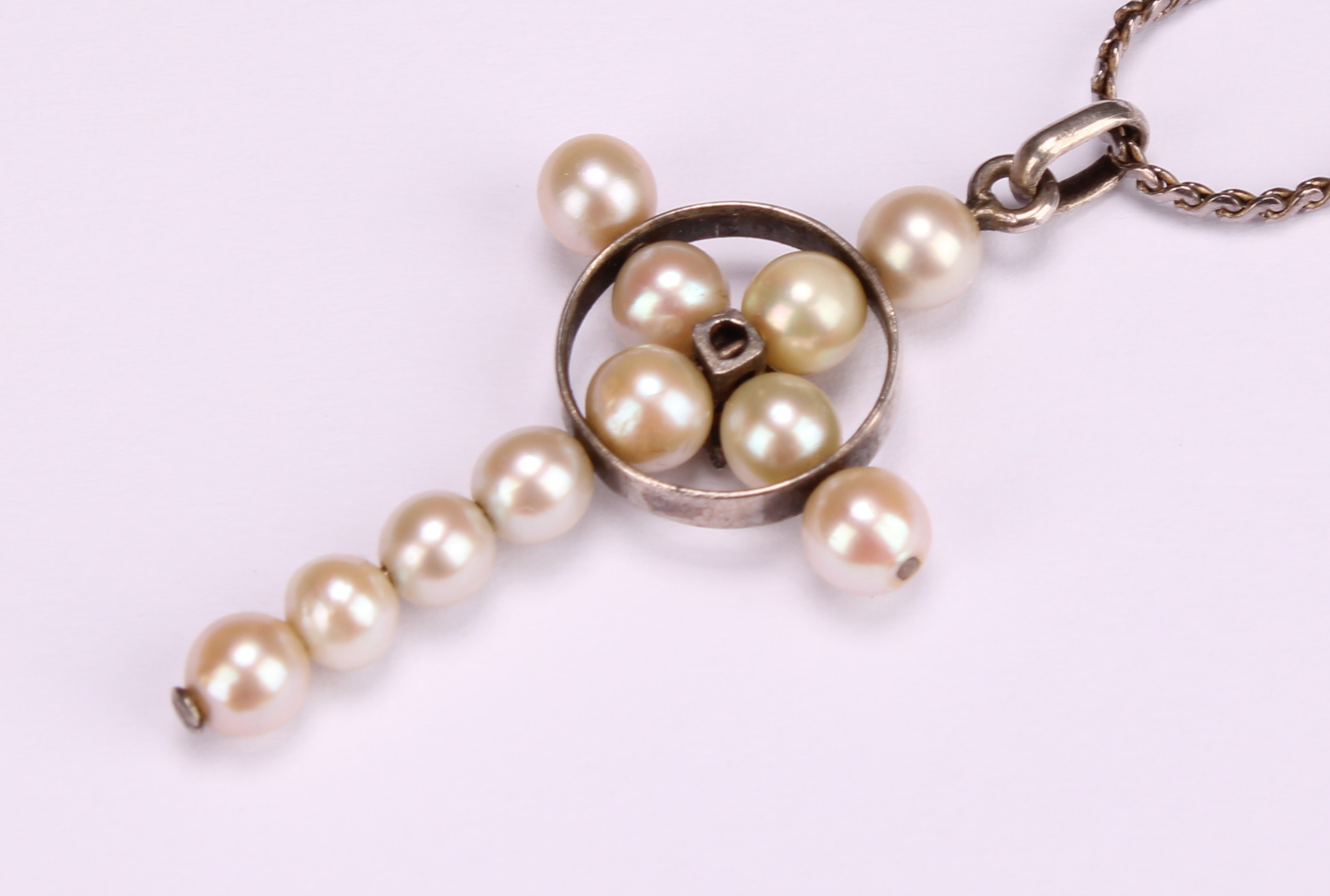 A natural pearl and spinel crucifix pendant, centred by a round cut pink stone, silver chain - Image 4 of 4