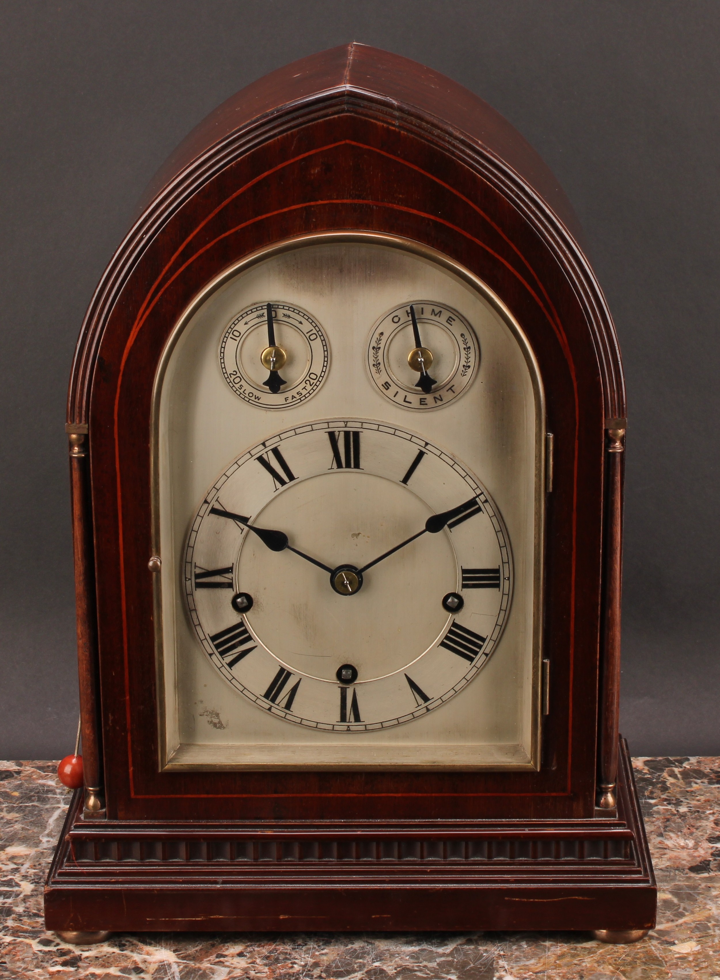 An early 20th century mahogany lancet bracket clock, 14.5cm arched silvered dial with Roman
