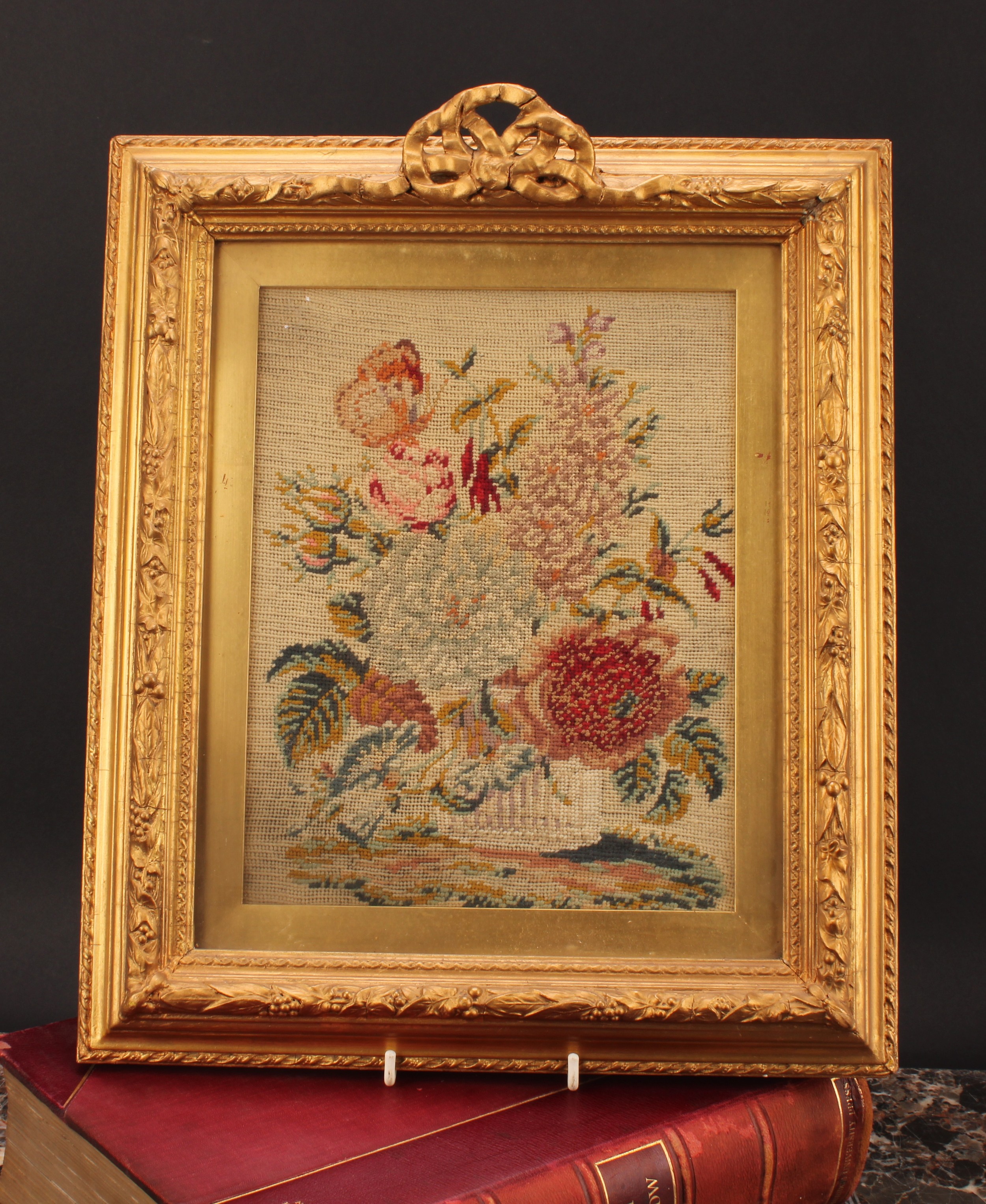 A 19th century woolwork panel, worked in colourful wools with study of flowers, rectangular giltwood