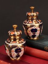 An associated pair of Royal Crown Derby 1128 Imari pattern ovoid vases, each with crown shaped