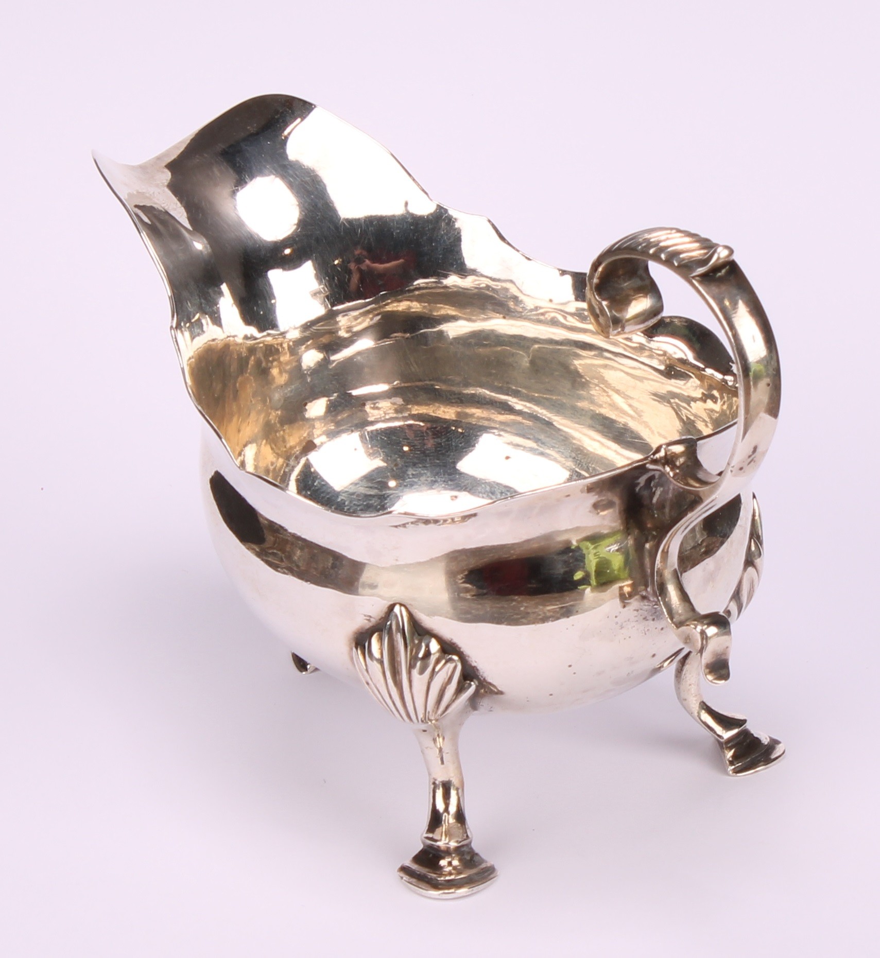 A George III silver sauce boat, acanthus-capped flying scroll handle, wavy rim, hoof feet, 13cm - Image 4 of 5