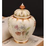 A Royal Worcester lobed ovoid pot pourri vase and cover, painted with flowers on an ivory ground,