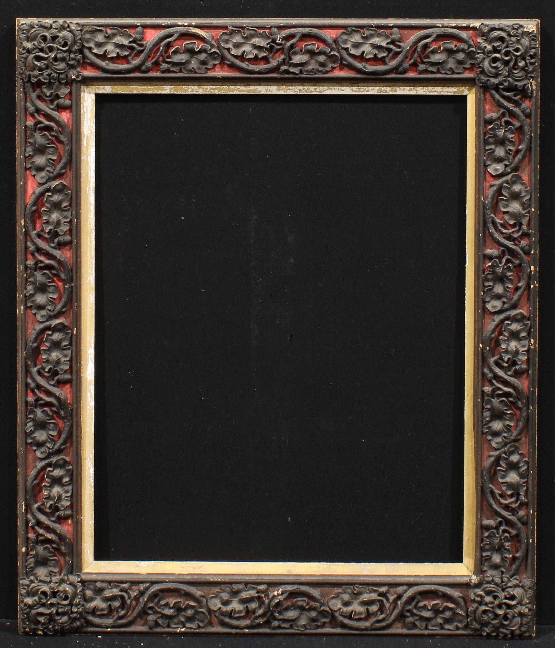 A Victorian rectangular gesso and wood picture frame, boldly applied with trailing oak leaves and