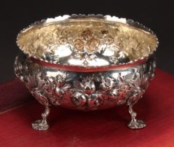A Victorian silver circular bowl, of 18th century Irish design, chased with flowers and stiff