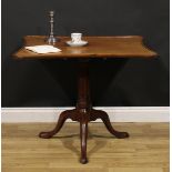 An unusual George III mahogany tripod supper table, dished incurve rectangular tilting top, fluted
