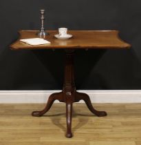 An unusual George III mahogany tripod supper table, dished incurve rectangular tilting top, fluted