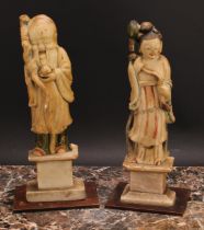 A pair of Chinese soapstone figures, carved as Shou Lao and Guanyin, each picked out in