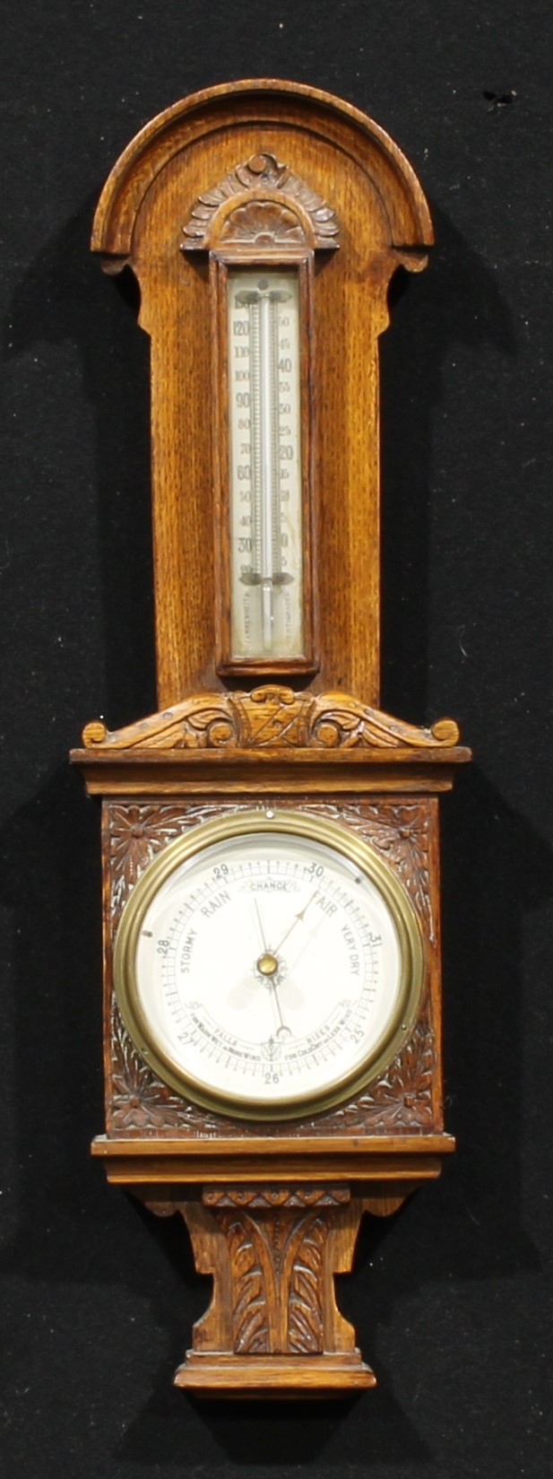 A late Victorian/Edwardian oak barometer, of smaller proportions, 10.5cm circular register, the