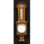 A late Victorian/Edwardian oak barometer, of smaller proportions, 10.5cm circular register, the