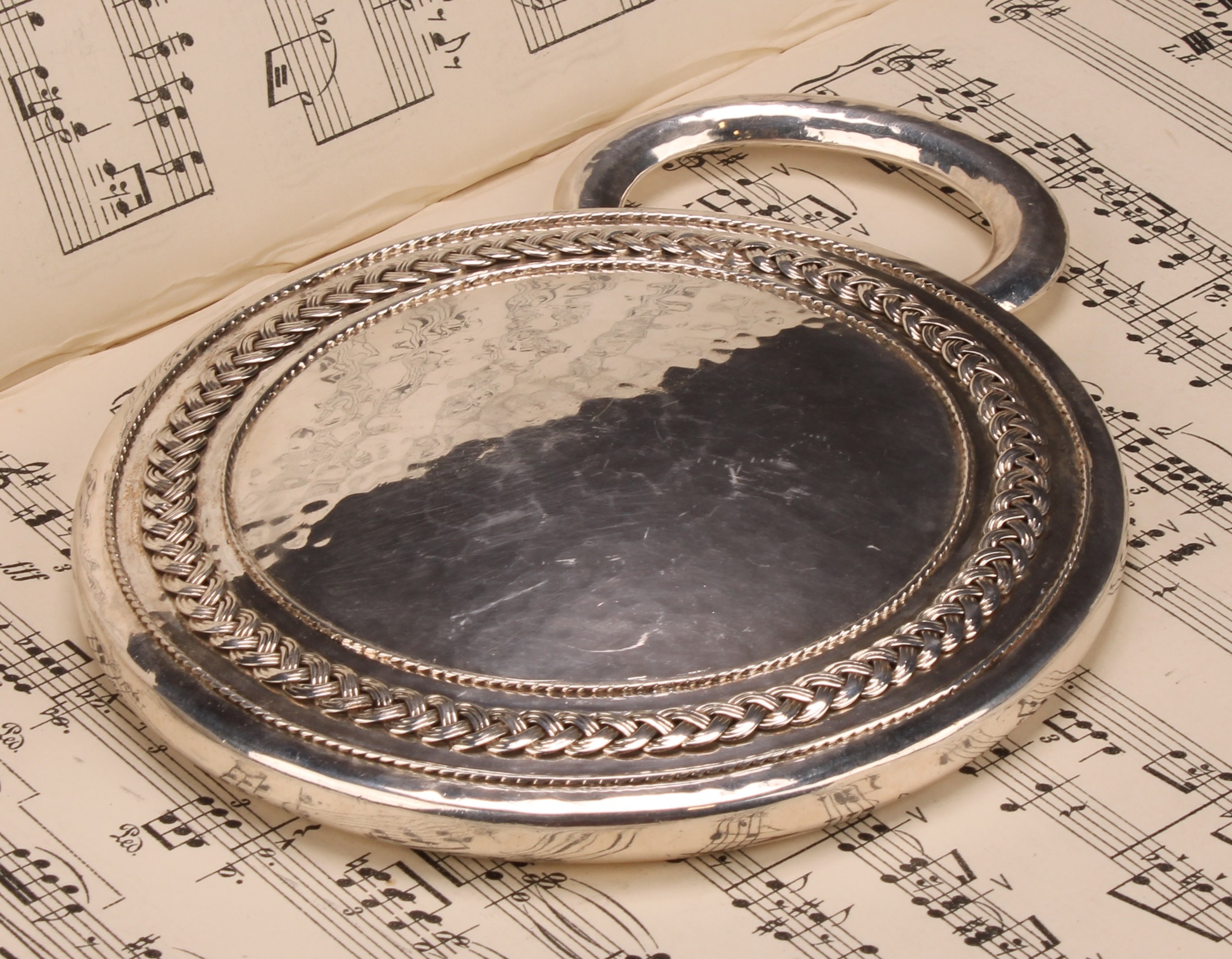 Amy Sandheim (1875 - 1958) - an Arts and Crafts silver circular hand mirror, Celtic knotted