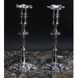 A pair of George II cast silver table candlesticks, unusually tall detachable nozzles, knopped