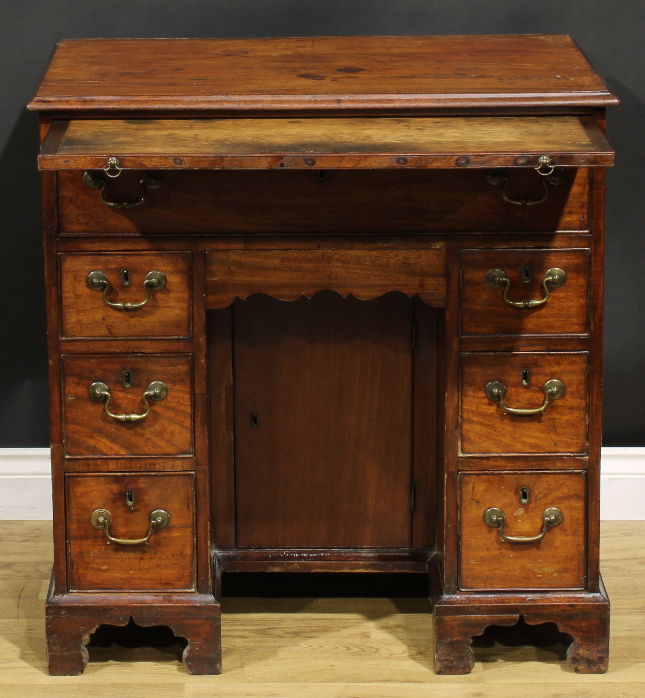 A George III mahogany kneehole desk, the ovolu moulded top above a brushing slide, axe head handles, - Image 3 of 8