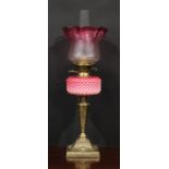 A Victorian brass and pink Vaseline glass table oil lamp, etched cranberry flashed shade, the base