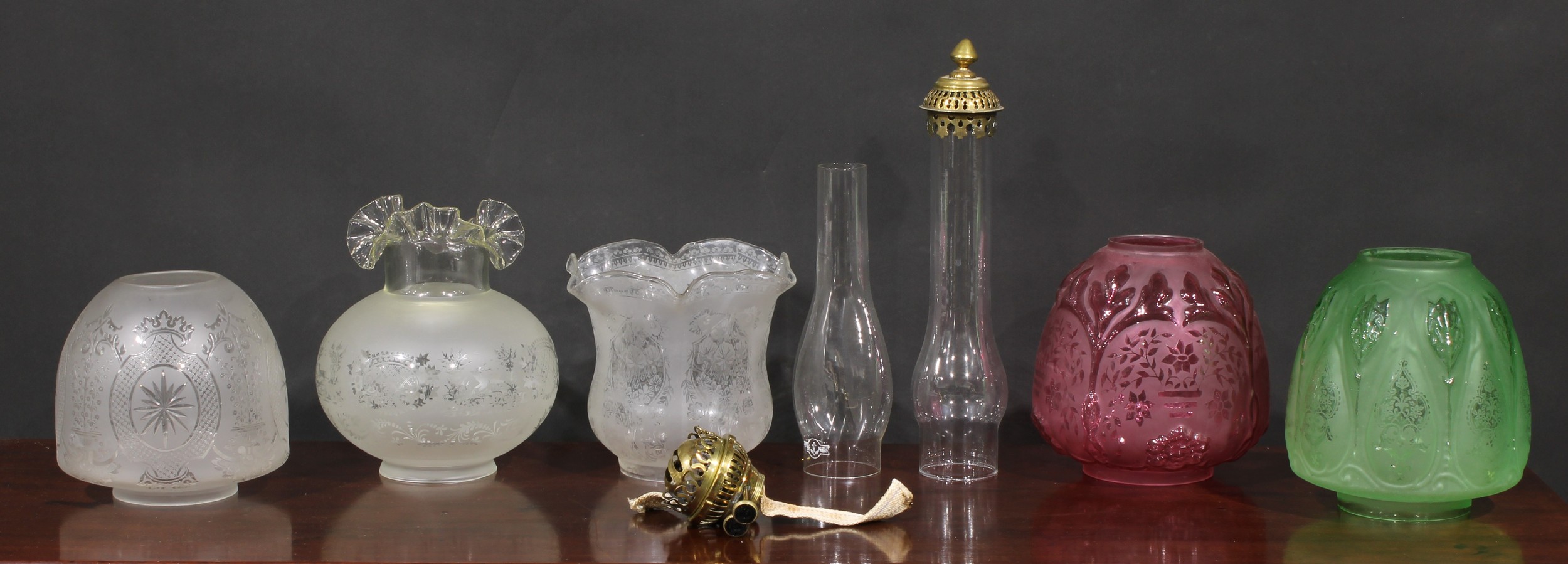 A 19th century ovoid cranberry glass oil lamp shade, frosted and moulded with flowers and foliage,