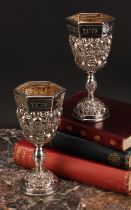 Judaica - a pair of Jewish silver Kiddush cups, profuesly chased with fruiting vine, gilt interiors,