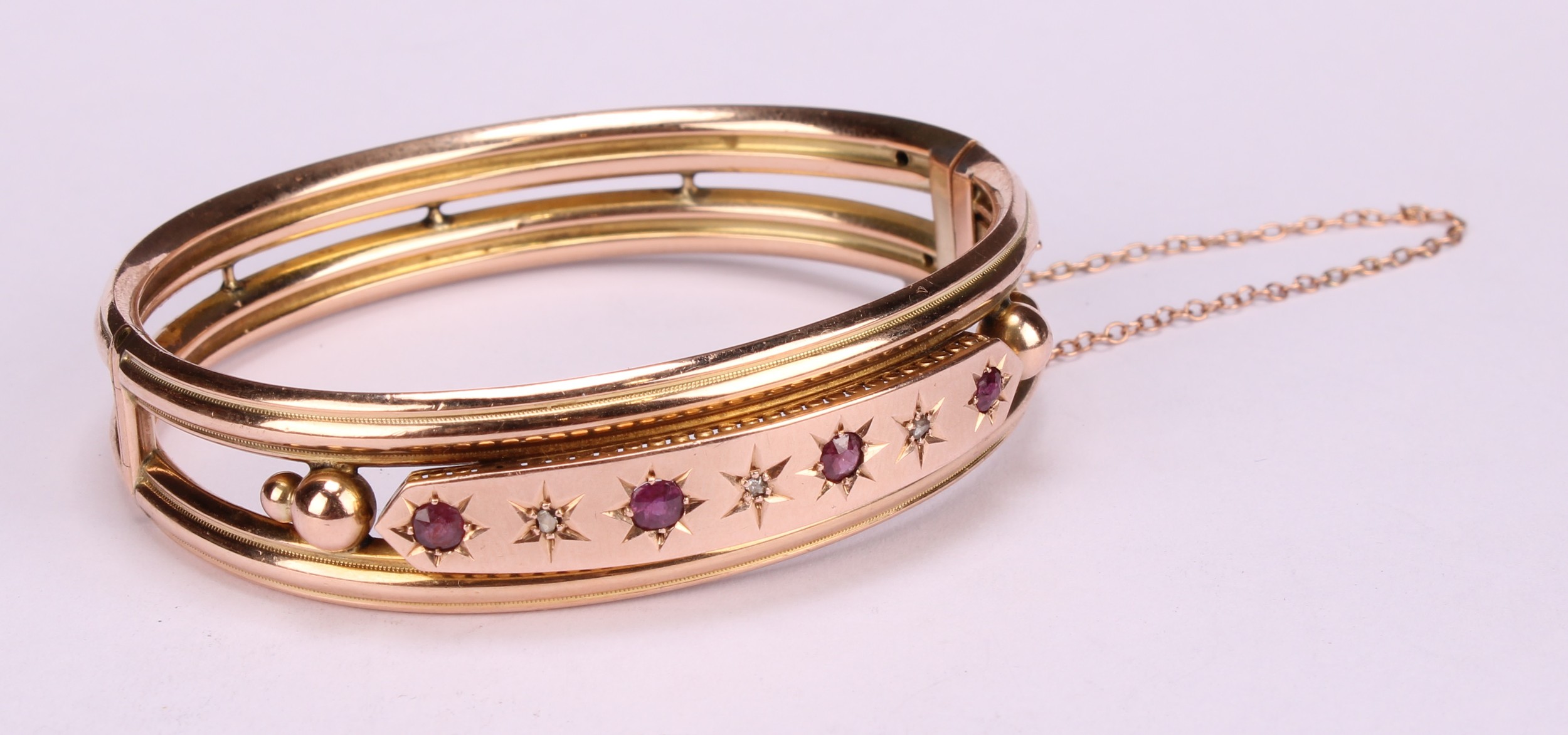 An Edwardian ruby and diamond 9ct gold hinge bangle, set with four old cut pinky red rubies, each - Image 3 of 5