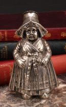 A large German silver novelty pepper, as a young Dutch girl traditionally dressed, 13cm high,