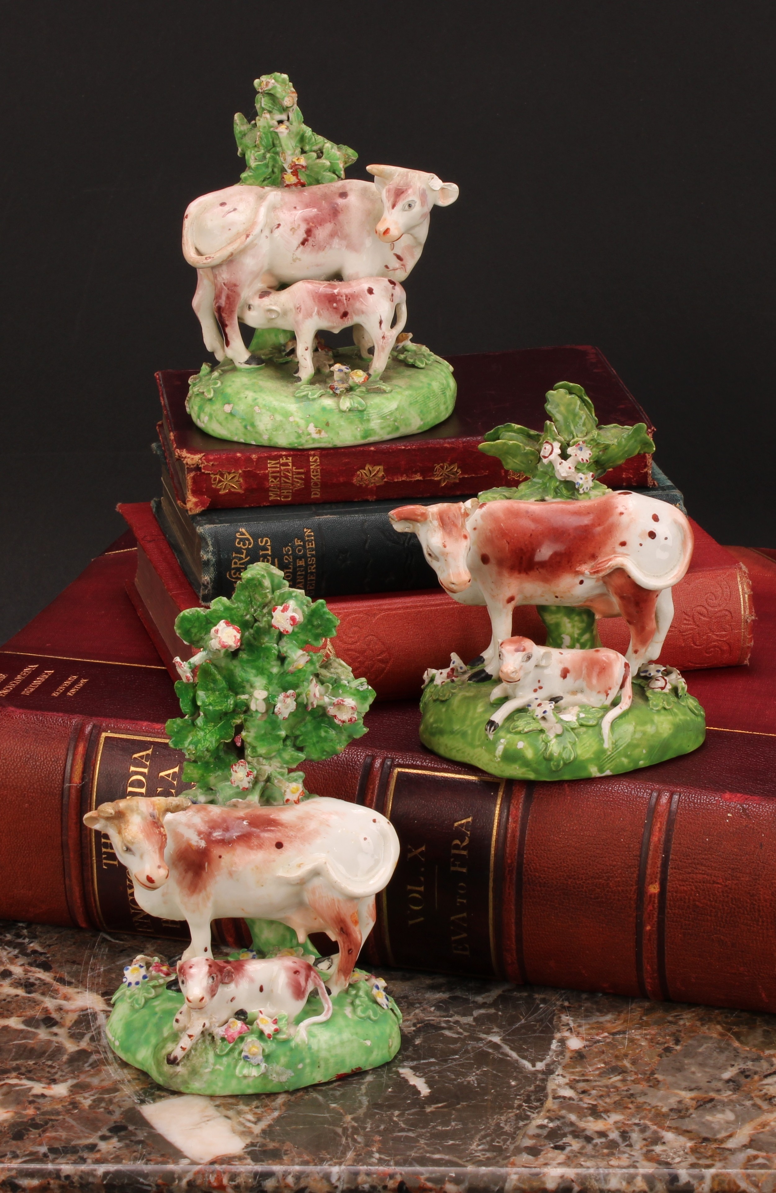 A Derby model, of a cow and her calf, beside a tree, 15cm high, c.1815; others similar (3)