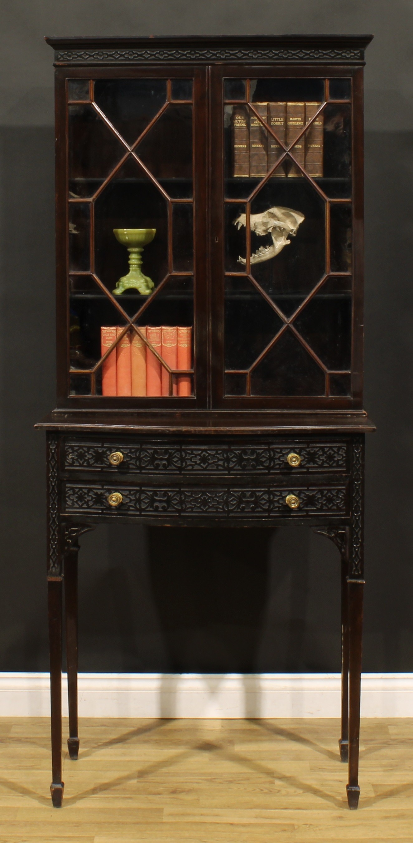 A Chippendale Revival mahogany and blind fretwork library bookcase, moulded cornice above a pair
