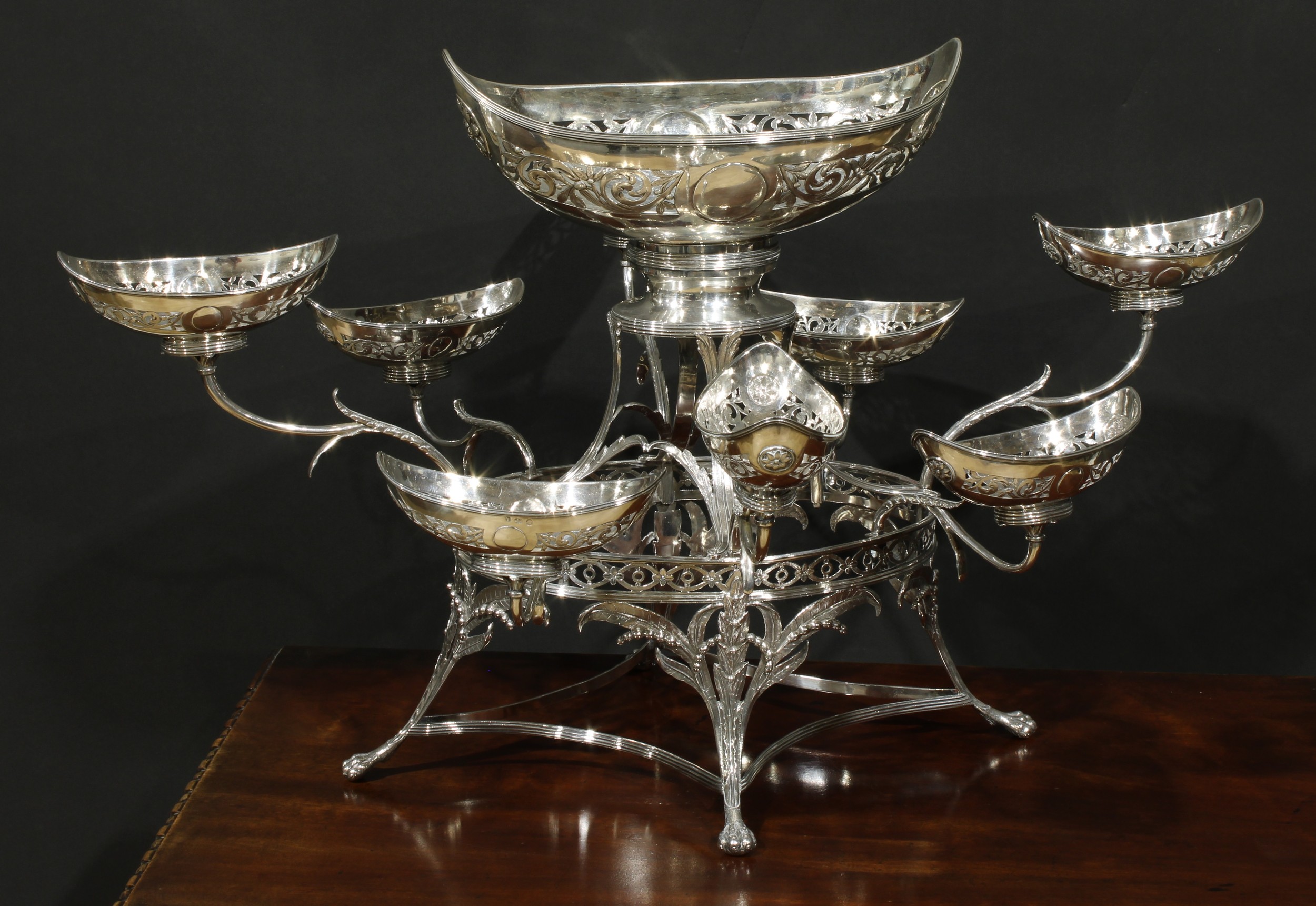A George III silver table centrepiece epergne, central boat shaped dish above eight scroll