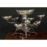 A George III silver table centrepiece epergne, central boat shaped dish above eight scroll