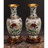 A pair of Japanese cloisonné enamel baluster vases, decorated with flowers and butterflies, hardwood