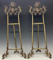A large pair of gilt metal baroque style easel stands, 80cm high open
