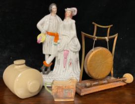 A Staffordshire flatback figural group; an Edwardian Arts and Crafts oak and brass table dinner