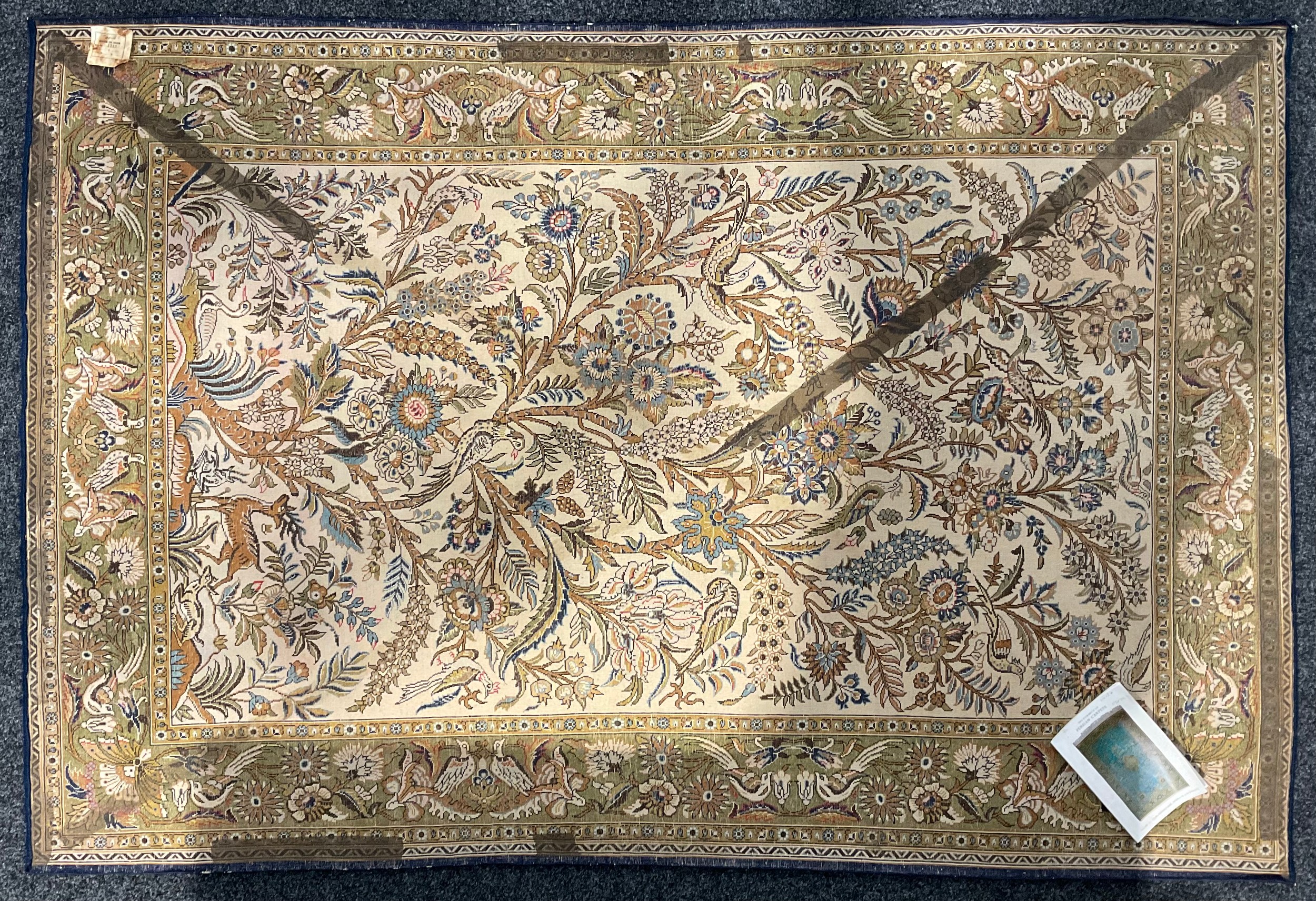 An Iranian silk Gohm type rug, decorated with birds and flowering foliage, in shades of golden - Image 2 of 3