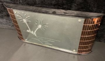 An Art Deco style wall mirror, the glass etched with palm trees, 37cm high, 74cm wide