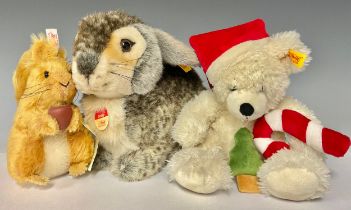 A Steiff rabbit, Dossy; a Steiff mohair Squirrel Nutkin, number 01292; a Steiff Christmas Bear (3)