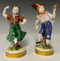 A pair of German Volkstedt porcelain allegorical figures, female dancer and male clown in peasant