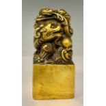 A contemporary Chinese solid cast gilt bronze dragon desk seal, set with turquoise and coral, 12cm