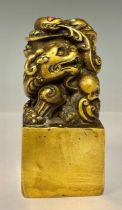 A contemporary Chinese solid cast gilt bronze dragon desk seal, set with turquoise and coral, 12cm